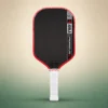 JOOLA Perseus Pro V 16mm Pickleball Paddle – Blaze Red (Ben Johns), front view on a sand and green studio background JOOLA Perseus Pro V 16mm Pickleball Paddle – Blaze Red (Ben Johns), front view