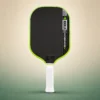JOOLA Kosmos Pro V 16mm Pickleball Paddle - Surge Green (Federico Staksrud), front view on a sand and green studio background JOOLA Kosmos Pro V 16mm Pickleball Paddle - Surge Green (Federico Staksrud), front view