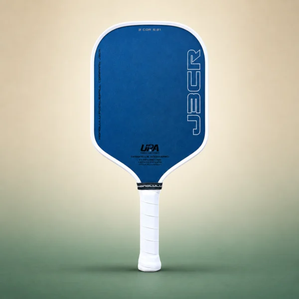 Honolulu J3CR Crystal Blue Endurance 16mm Pickleball Paddle - White, front view on a sand and green studio background Honolulu J3CR Crystal Blue Endurance 16mm Pickleball Paddle - White, front view
