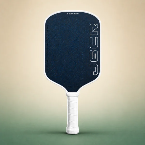 Honolulu J6CR Crystal Blue Endurance 16mm Pickleball Paddle - White, front view on a sand and green studio background Honolulu J6CR Crystal Blue Endurance 16mm Pickleball Paddle - White, front view