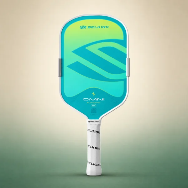 Selkirk OMNI Elongated paddle in Calypso, front view on a sand and green studio background Selkirk OMNI Elongated paddle in Calypso, front view